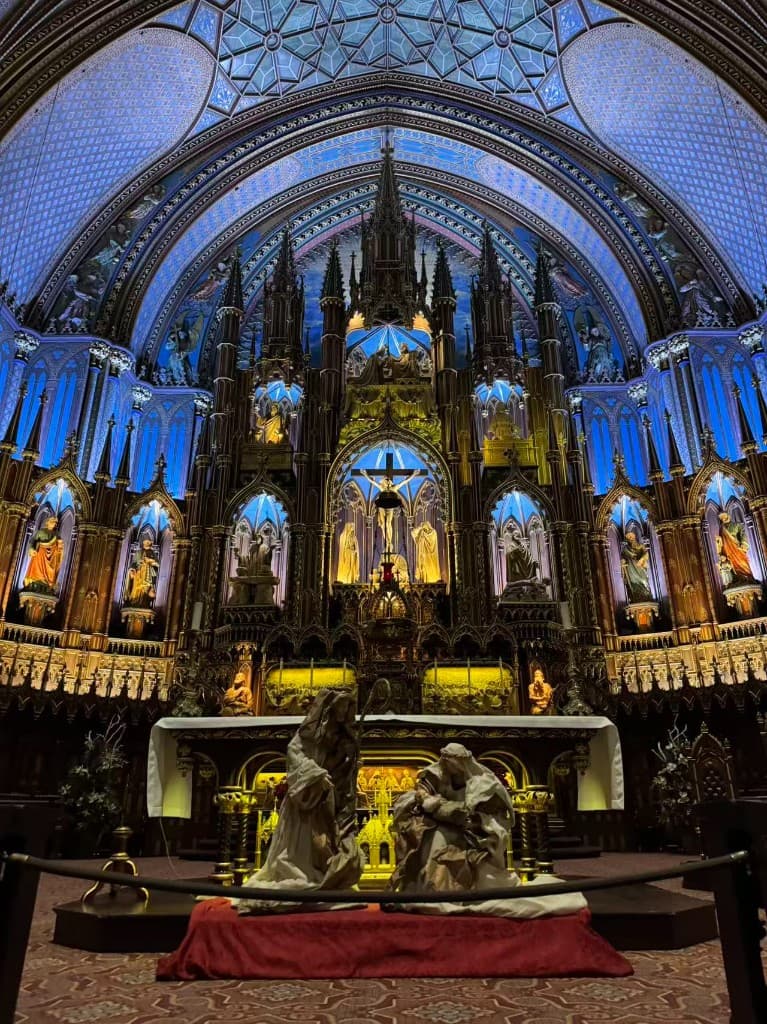 Interior of Notre-Dame Basilica with blue vaults, golden altar, and carved reredos, Montreal, Canada