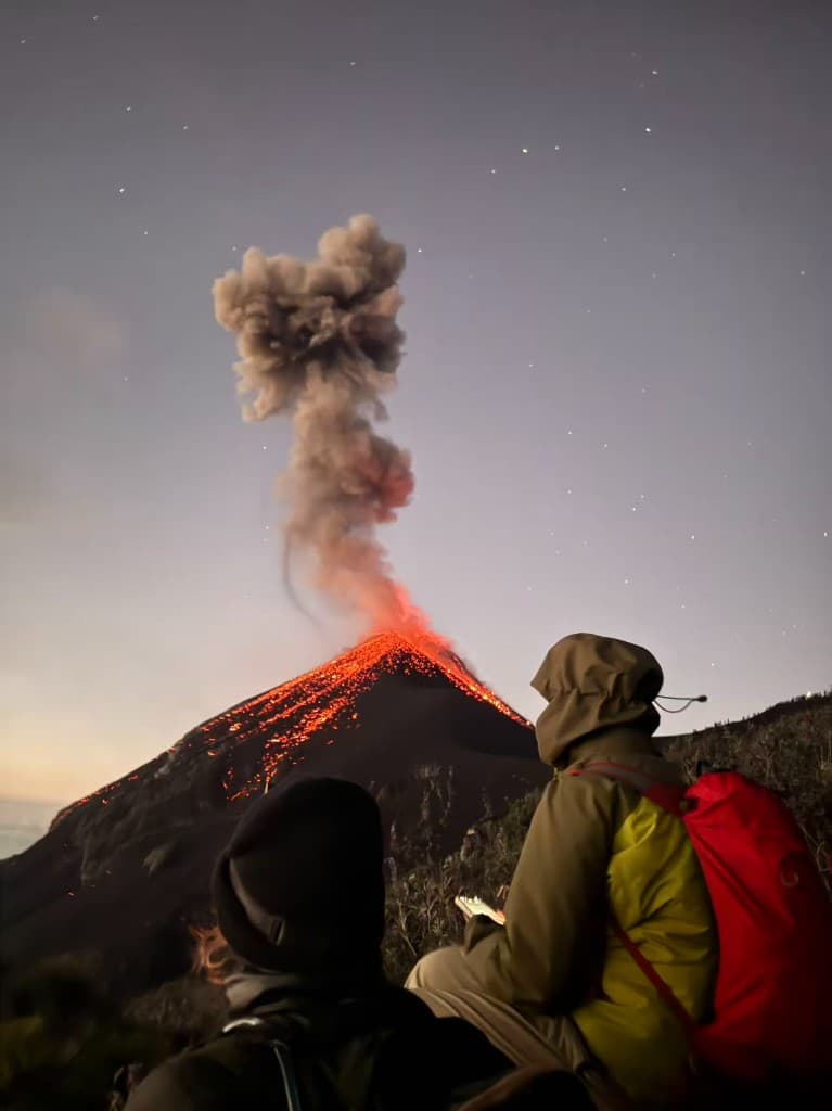 Volcán de Fuego erupting at night with lava and an ash plume, Guatemala